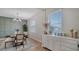 Dining area with a table, chairs, sideboard, and soft green accent wall at 5714 Broad River Run, Ellenton, FL 34222