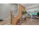 Welcoming foyer with wooden staircase and stylish décor leading to the main living area at 5714 Broad River Run, Ellenton, FL 34222