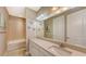 Bathroom with tiled walls, white vanity, and decorative starfish at 5737 Semolino St, Nokomis, FL 34275
