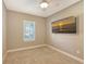 Empty bedroom with neutral walls, white trim, and plantation shutters at 5737 Semolino St, Nokomis, FL 34275