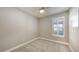 Empty bedroom with neutral walls, white trim, and plantation shutters at 5737 Semolino St, Nokomis, FL 34275