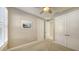 Spacious bedroom with neutral walls, white trim, and plantation shutters at 5737 Semolino St, Nokomis, FL 34275