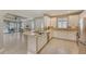 White kitchen with stainless steel appliances, breakfast bar, and view of pool at 5737 Semolino St, Nokomis, FL 34275