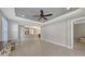 Open living area with tile floors, ceiling fan, and view into kitchen at 5737 Semolino St, Nokomis, FL 34275