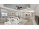 Living area features a white sofa, decorative rug, and view of the adjacent kitchen at 5737 Semolino St, Nokomis, FL 34275