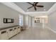 Open living area with tile flooring, ceiling fan, and view of the kitchen at 5737 Semolino St, Nokomis, FL 34275