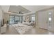 Bright living room with white sofa, view of pool, and access to backyard at 5737 Semolino St, Nokomis, FL 34275