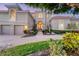 Elegant two-story home with a three-car garage and manicured landscaping at 591 Putting Green Ln, Longboat Key, FL 34228