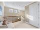 Bright hallway with natural light, cozy seating, and wrought iron railing at 591 Putting Green Ln, Longboat Key, FL 34228