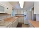 Kitchen with white cabinets, wood countertops and appliances at 5927 17Th W St # A21, Bradenton, FL 34207