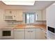 Bright kitchen features white cabinets, wood countertops, and modern appliances at 5927 17Th W St # A21, Bradenton, FL 34207