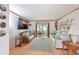 Living room features a large TV, comfy seating, and wood floors at 5927 17Th W St # A21, Bradenton, FL 34207