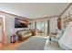 Living room with couches, a TV, and access to a patio at 5927 17Th W St # A21, Bradenton, FL 34207