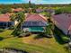 An aerial view of a house with a pool and tropical landscaping at 616 Misty Pond Ct, Bradenton, FL 34212