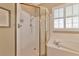 Bathroom with shower, soaking tub, and gold-framed glass enclosure at 616 Misty Pond Ct, Bradenton, FL 34212