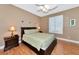 Bedroom featuring a wooden bedframe, nightstands, and a window with shutters at 616 Misty Pond Ct, Bradenton, FL 34212