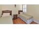 Bedroom featuring two twin beds, a nightstand, and window with shutters at 616 Misty Pond Ct, Bradenton, FL 34212