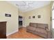 Secondary bedroom with ceiling fan, couch, and doorway to another room at 616 Misty Pond Ct, Bradenton, FL 34212