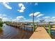 Wooden boat dock with multiple boats and calm water at 616 Misty Pond Ct, Bradenton, FL 34212