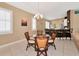 Charming dining area with a glass-top table, wicker chairs, and ample natural light at 616 Misty Pond Ct, Bradenton, FL 34212