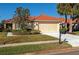 Inviting front yard with a paved driveway and manicured lawn at 616 Misty Pond Ct, Bradenton, FL 34212