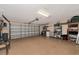 Two-car garage with storage shelves and cabinets at 616 Misty Pond Ct, Bradenton, FL 34212