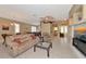 Open-concept living room and dining area with tile flooring, ceiling fan, and entertainment center at 616 Misty Pond Ct, Bradenton, FL 34212