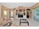 Open living room with built-in entertainment center, tile floors, and access to the patio at 616 Misty Pond Ct, Bradenton, FL 34212