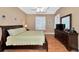 Large main bedroom with wooden furniture, a ceiling fan, and windows with shutters at 616 Misty Pond Ct, Bradenton, FL 34212