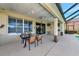 Covered patio with a table, chairs, and a view of the pool and golf course at 616 Misty Pond Ct, Bradenton, FL 34212