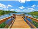 Wooden dock extending over calm water under blue sky at 616 Misty Pond Ct, Bradenton, FL 34212