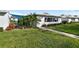 Quaint home with lush landscaping, a welcoming walkway, and a covered patio area at 6913 8Th W Ave, Bradenton, FL 34209