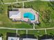 Aerial view of community pool with a pool house and lounge chairs at 6913 8Th W Ave, Bradenton, FL 34209