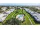 Lovely aerial view of a community featuring homes surrounding a refreshing swimming pool and green spaces at 6913 8Th W Ave, Bradenton, FL 34209