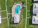 Aerial view of community pool with a pool house and lounge chairs at 6913 8Th W Ave, Bradenton, FL 34209