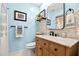 Charming bathroom featuring a modern vanity with marble countertop, stylish mirror, and refreshing blue walls at 6913 8Th W Ave, Bradenton, FL 34209