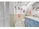Bathroom features white and blue cabinets and shower with glass doors at 6913 8Th W Ave, Bradenton, FL 34209
