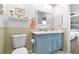 Charming bathroom with blue vanity, white countertop, and decorative mirror at 6913 8Th W Ave, Bradenton, FL 34209