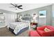 This bedroom features light-green walls, luxury vinyl plank floors, a ceiling fan, and a closet with folding doors at 6913 8Th W Ave, Bradenton, FL 34209