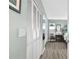 Bright bedroom featuring a wall of white closet doors and gray wood flooring at 6913 8Th W Ave, Bradenton, FL 34209