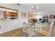Dining area with pass-through to the kitchen and views of the living room, featuring modern lighting at 6913 8Th W Ave, Bradenton, FL 34209