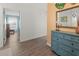 Bright entryway featuring wood floors and a blue dresser with decor at 6913 8Th W Ave, Bradenton, FL 34209