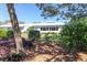 Charming single-story home with lush landscaping, mature trees, and a well-manicured lawn at 6913 8Th W Ave, Bradenton, FL 34209