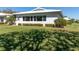 Well-maintained home exterior with a vibrant green lawn, trimmed hedges, and a bright, appealing aesthetic at 6913 8Th W Ave, Bradenton, FL 34209