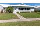 Charming home exterior with well-manicured lawn, mature landscaping, and a welcoming entryway at 6913 8Th W Ave, Bradenton, FL 34209