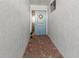 A beautiful light blue front door leads to a property with detailed walls and brick flooring at 6913 8Th W Ave, Bradenton, FL 34209