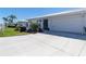 A well-maintained front lawn and driveway lead to an attached two-car garage at 6913 8Th W Ave, Bradenton, FL 34209