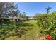 Beautifully landscaped front yard with vibrant flowers, manicured hedges, and lush green grass at 6913 8Th W Ave, Bradenton, FL 34209