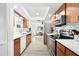 Modern kitchen featuring sleek countertops and stainless steel appliances with views of the living area at 6913 8Th W Ave, Bradenton, FL 34209