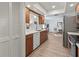 Bright kitchen featuring stainless steel appliances, quartz countertops, and wood cabinets, open to the living area at 6913 8Th W Ave, Bradenton, FL 34209